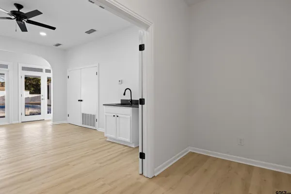 a view of empty room with wooden floor and window