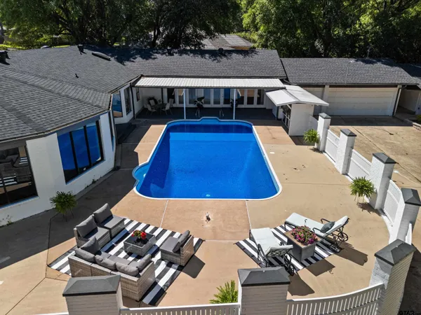 an aerial view of a house with swimming pool garden and patio