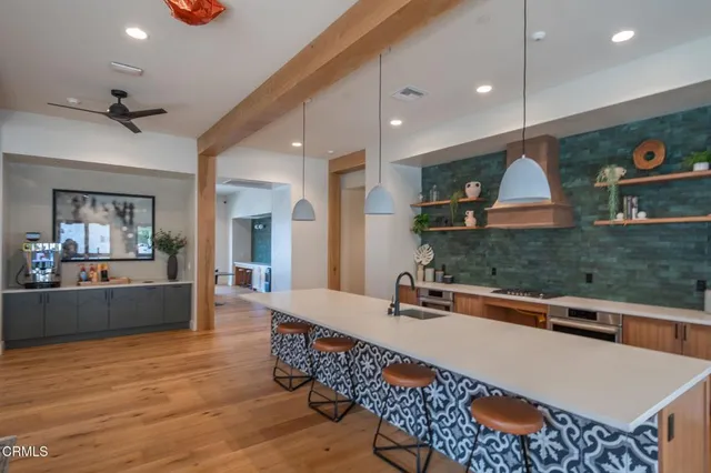 a kitchen with stainless steel appliances granite countertop a sink and a wooden cabinets