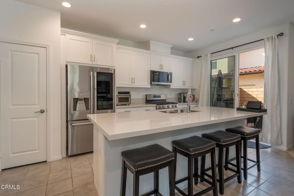 231 Inspiration Camarillo, CA 93012 - Photo 5 of 47 a kitchen with kitchen island cabinets and refrigerator