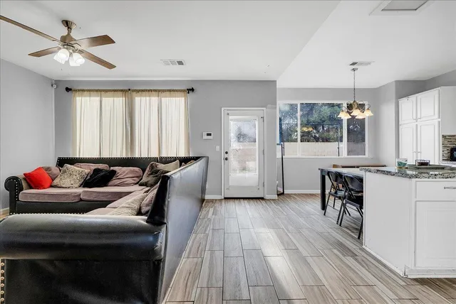 a living room with furniture and wooden floor