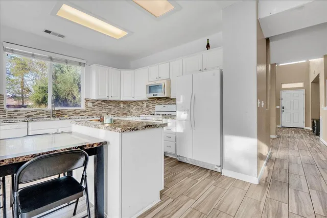 a kitchen with kitchen island a stove a sink and a refrigerator