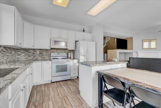 a kitchen with a stove a sink and a refrigerator