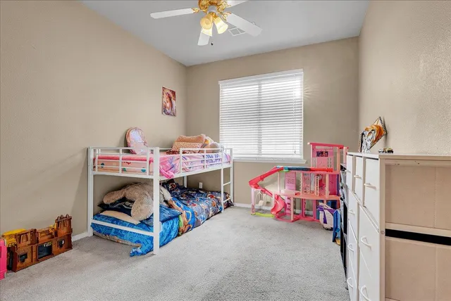 a bedroom with bed and a chandelier