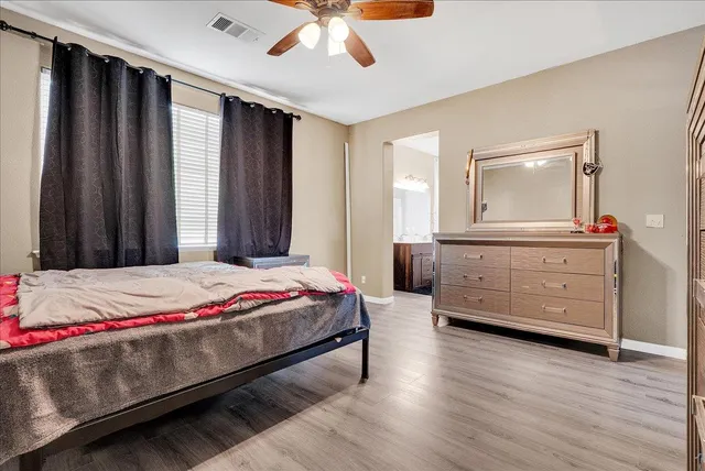 a bedroom with a bed and a dresser