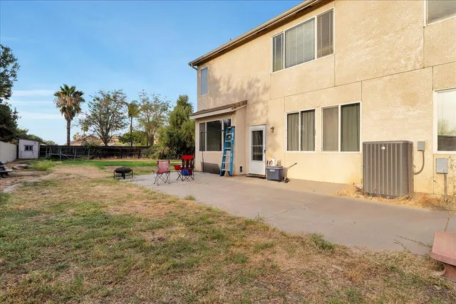 a view of a house with backyard and sitting area