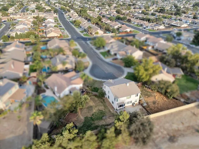 an aerial view of residential houses with outdoor space