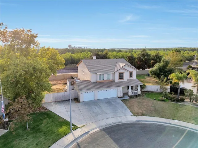 an aerial view of a house with a yard