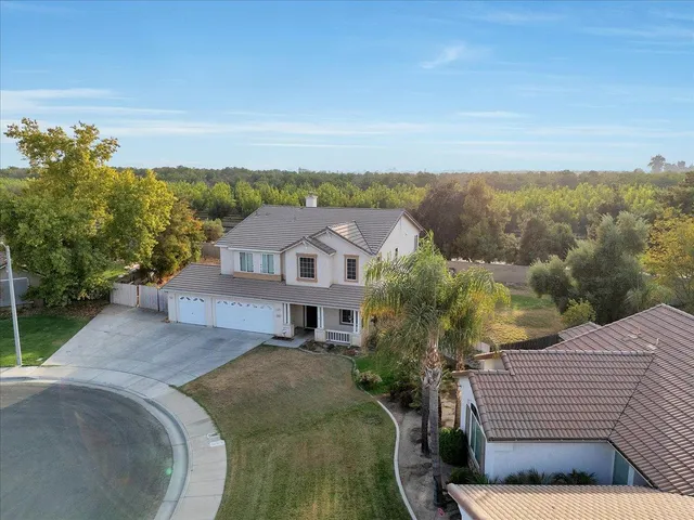 an aerial view of a house with big yard