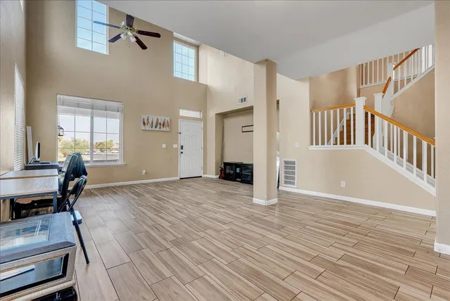a view of a livingroom with furniture and staircase