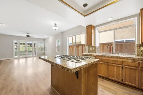 a kitchen with stainless steel appliances granite countertop a stove a sink and a refrigerator