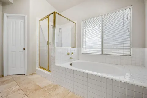 a bathroom with a bathtub and a shower