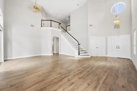 a view of empty room with wooden floor