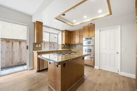 a kitchen with a stove and a refrigerator