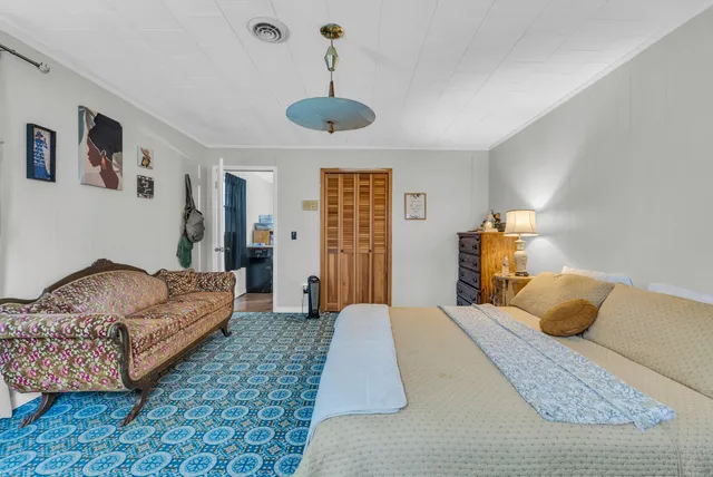 a bedroom with a bed and a chandelier