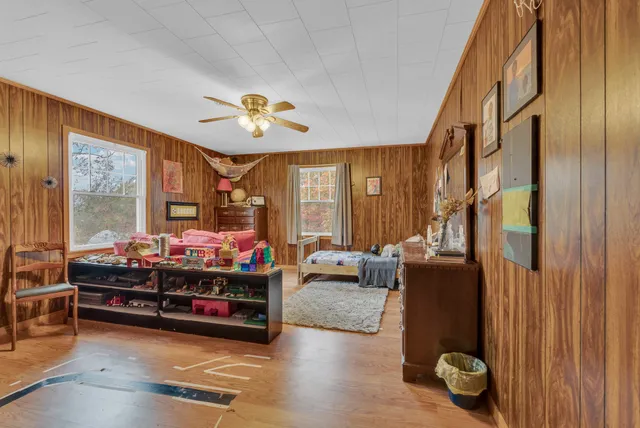a living room with a bed furniture and a window