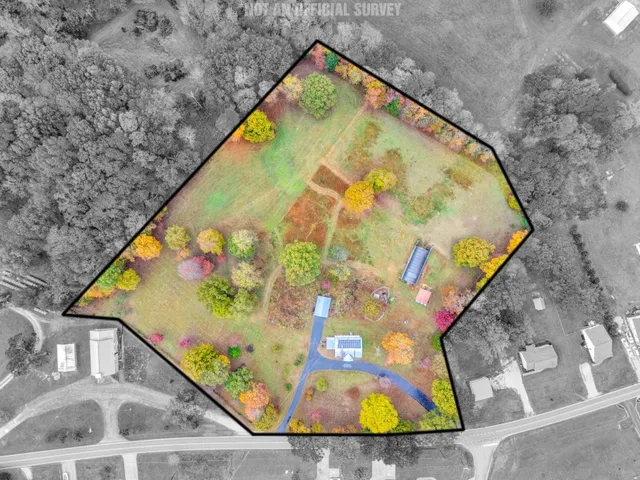 a view of a white house with a yard