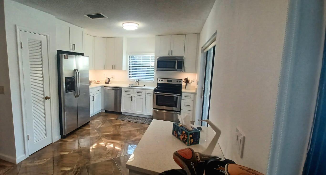 10544 Fenway Place Boca Raton, FL 33498 - Photo 13 of 28 a kitchen with stainless steel appliances granite countertop a refrigerator and a stove top oven