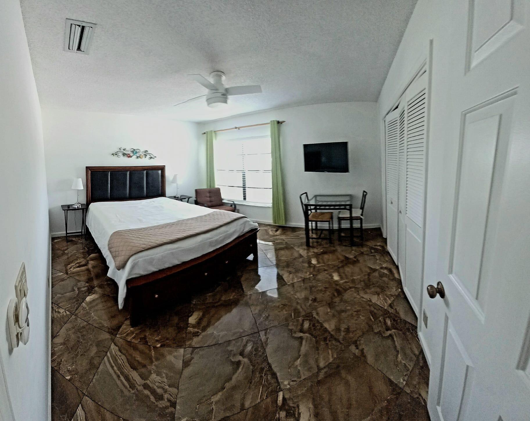 10544 Fenway Place Boca Raton, FL 33498 - Photo 22 of 28 a living room with a bed furniture and a flat screen tv