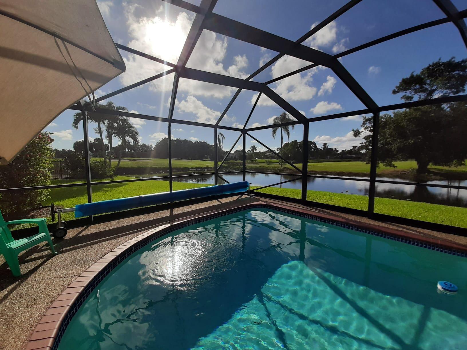10544 Fenway Place Boca Raton, FL 33498 - Photo 6 of 28 a view of a swimming pool with a yard