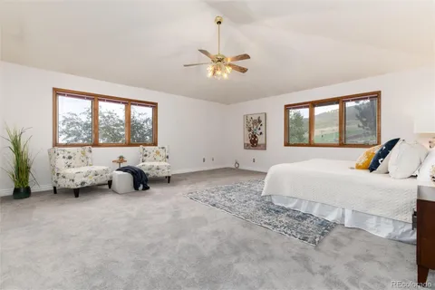 a spacious bedroom with a bed and a chandelier