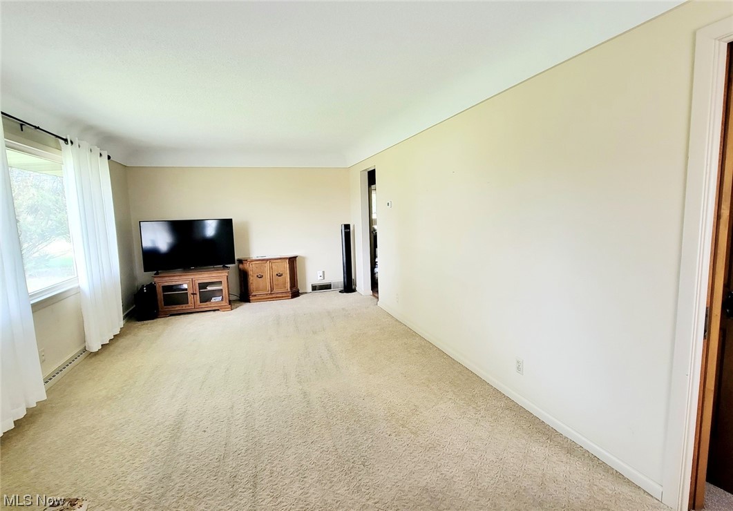 6416 Milan Road Sandusky, OH 44870 - Photo 8 of 34 Carpeted living room with big window
