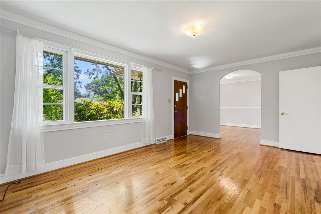 1509 869 Anderson, SC 29621 - Photo 8 of 45 Natural light floods this living space, highlighting the warm wood flooring and inviting atmosphere.