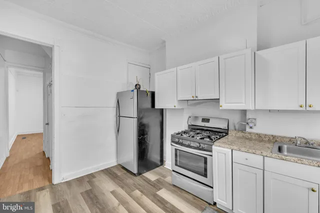 a kitchen with cabinets appliances and a counter space