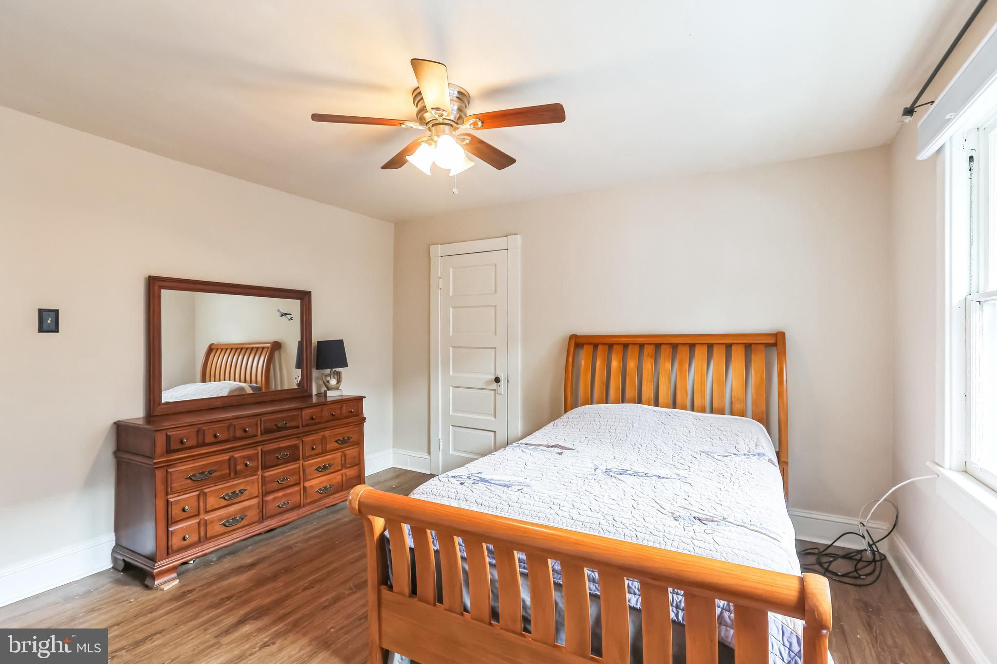 127 Sycamore Road Riegelsville, PA 18077 - Photo 19 of 34 a bedroom with a bed and a chandelier