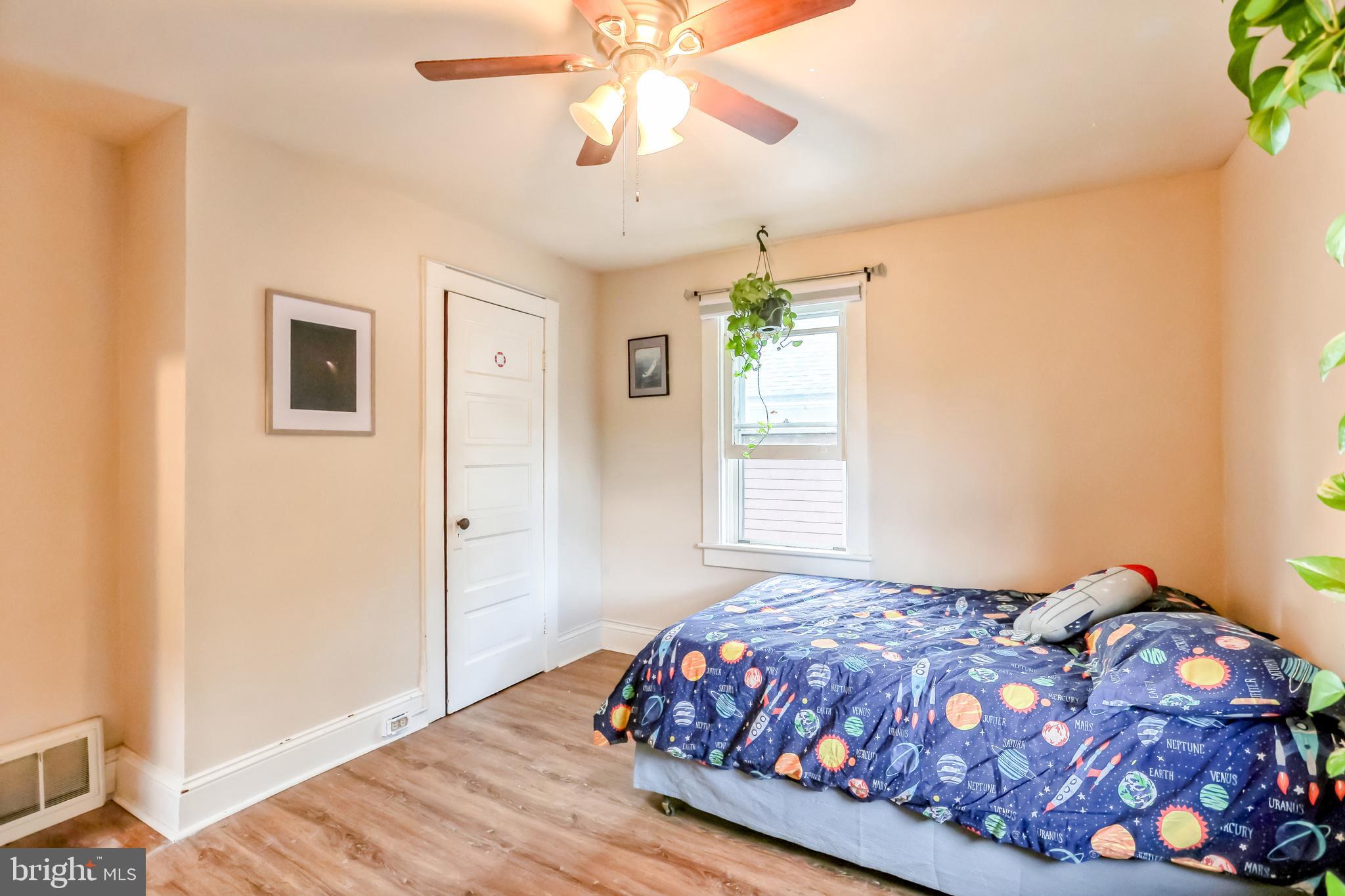 127 Sycamore Road Riegelsville, PA 18077 - Photo 27 of 34 a bedroom with a bed and a chandelier