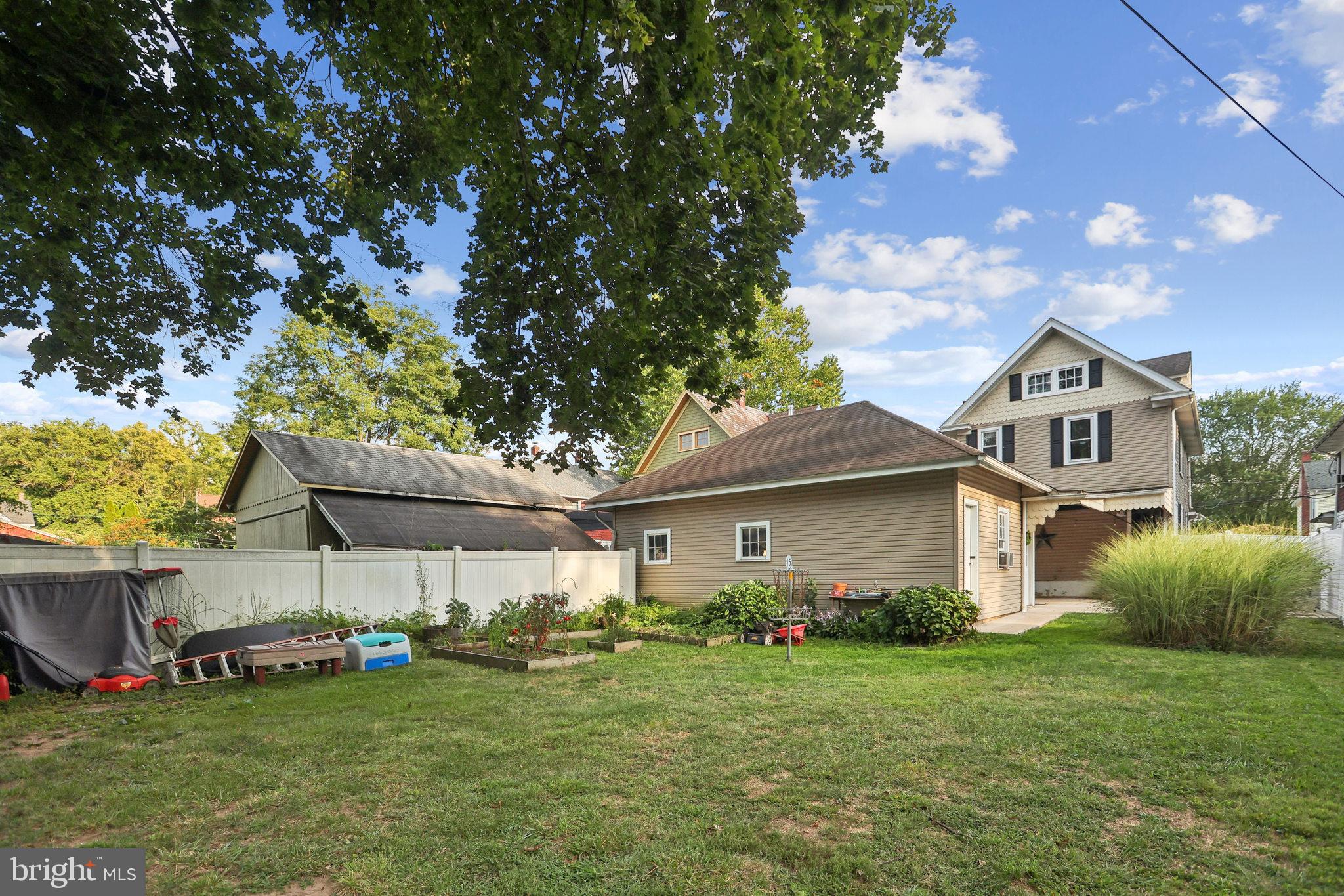 127 Sycamore Road Riegelsville, PA 18077 - Photo 3 of 34 a front view of a house with a garden and plants