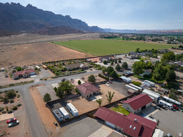 4297 Beeman Road Moab, UT 84532 - Photo 51 of 59 Expansive property featuring multiple structures, including two homes with red metal roofs