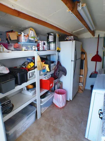 a kitchen with cabinets and wooden floor