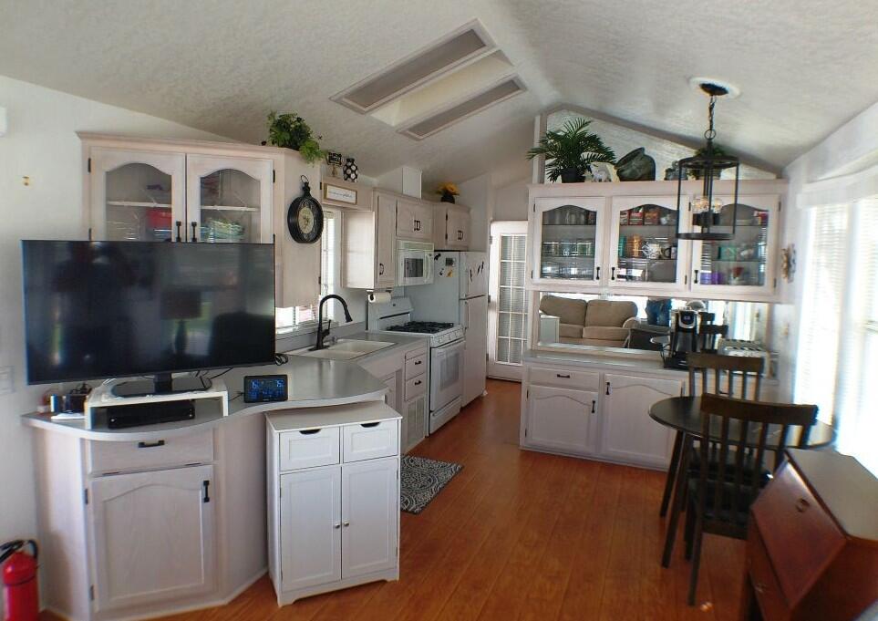 84136 Ave 44, Unit 628 Indio, CA 92203 - Photo 15 of 34 a kitchen with cabinets and wooden floor