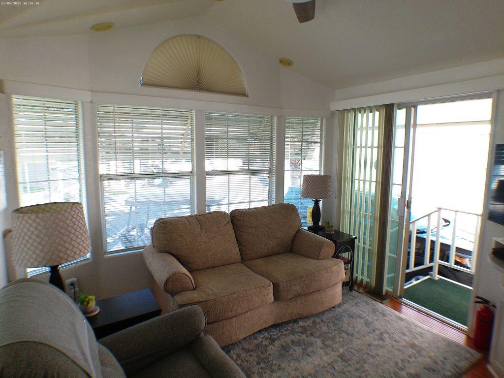 84136 Ave 44, Unit 628 Indio, CA 92203 - Photo 17 of 34 a living room with furniture and a floor to ceiling window