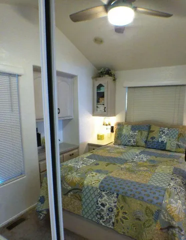 a bedroom with a bed and a view of en suite bathroom