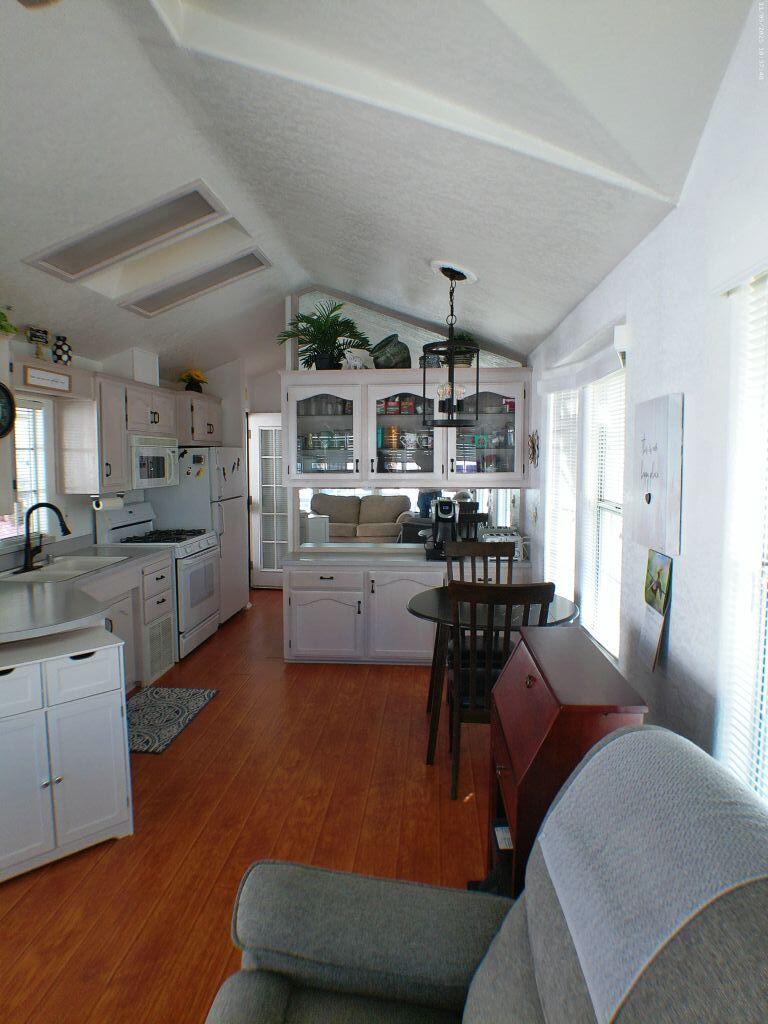 84136 Ave 44, Unit 628 Indio, CA 92203 - Photo 34 of 34 a kitchen with stainless steel appliances kitchen island granite countertop a refrigerator a sink a stove and white cabinets