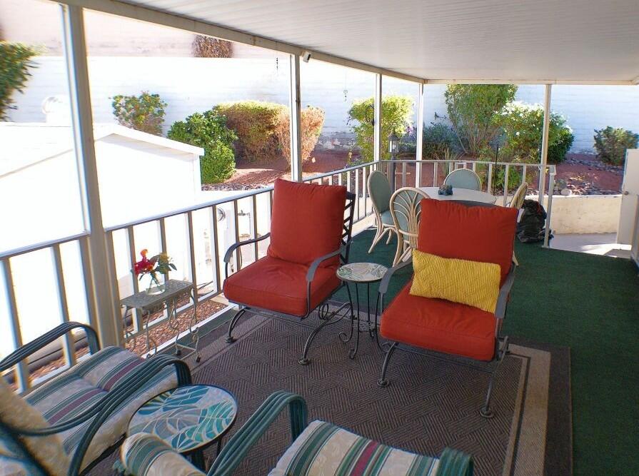 84136 Ave 44, Unit 628 Indio, CA 92203 - Photo 7 of 34 a balcony view with a couch a table and chairs