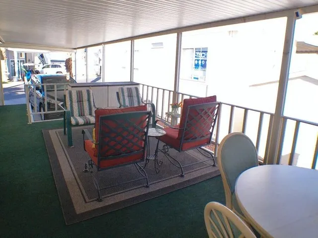 a living room with furniture rug and wooden floor