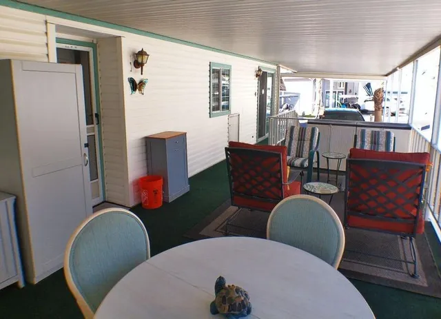 a front view of a house with a yard and potted plants