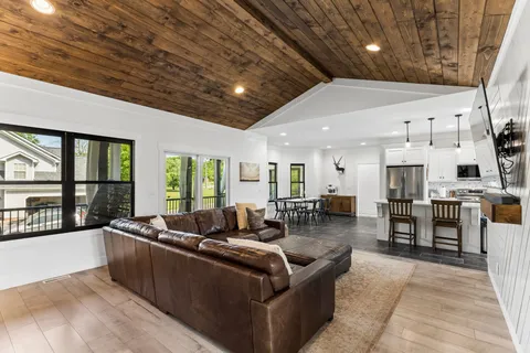 a large kitchen with kitchen island a stove a sink a microwave a refrigerator and cabinets
