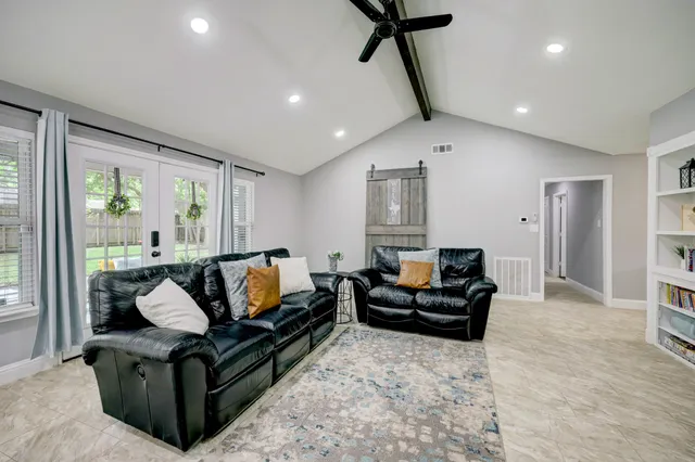 a living room with furniture and a flat screen tv
