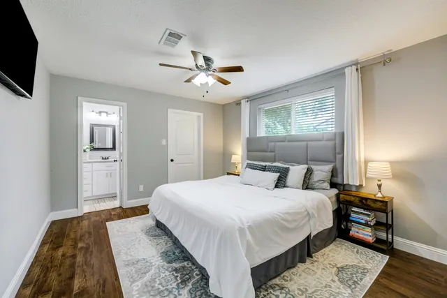 a bathroom with a granite countertop sink toilet and mirror
