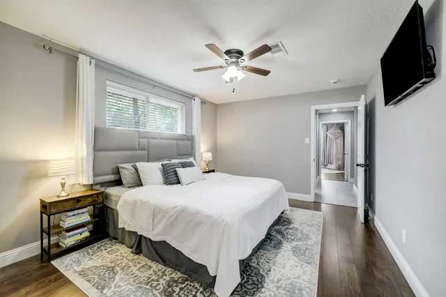 a bedroom with a large bed and a tv