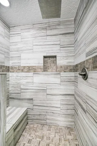 a bathroom with a granite countertop sink mirror and toilet