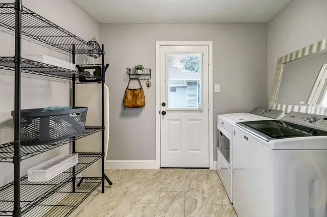 a kitchen with a stove a refrigerator and cabinets