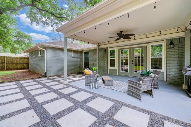 a building outdoor space with patio furniture and potted plants