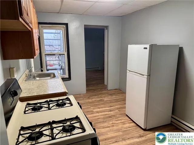 a kitchen with a stove and a refrigerator