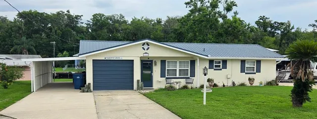 a view of a yard in front view of a house
