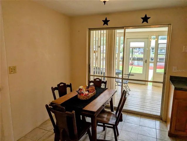 a dining room with furniture a chandelier and wooden floor